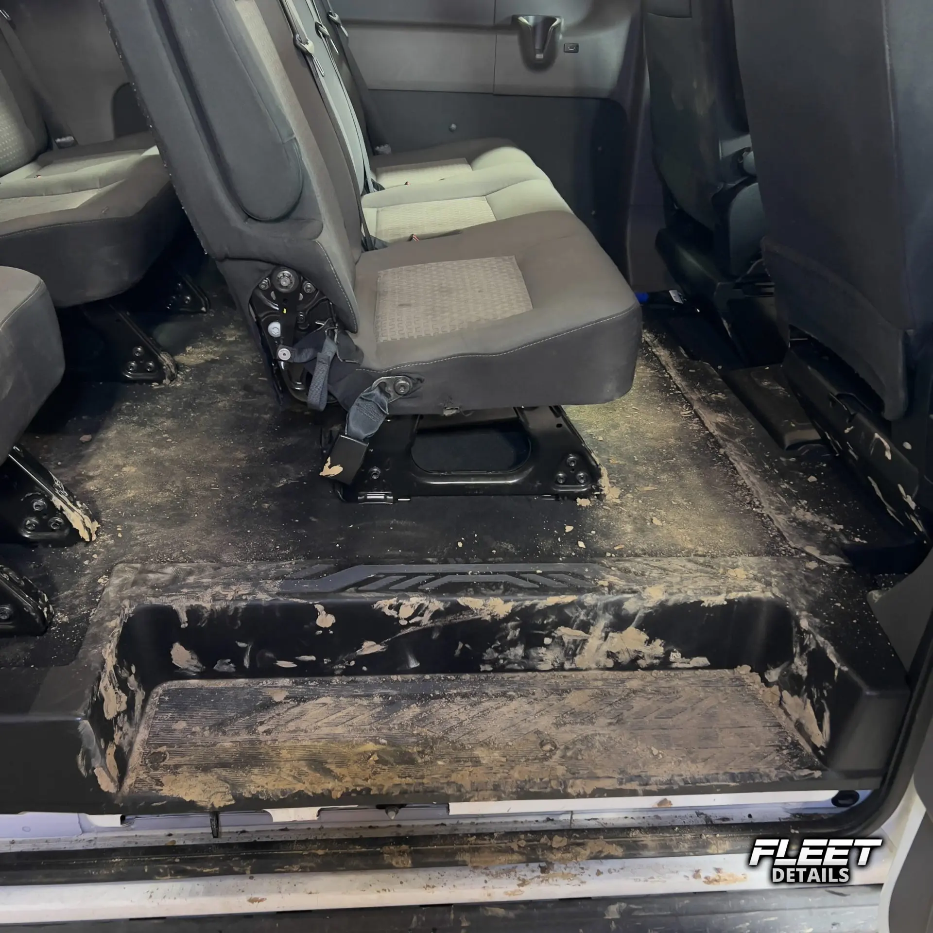 Inside of a vehicle's interior showing the dashboard and seats and carpet cleaned from an interior mobile detail