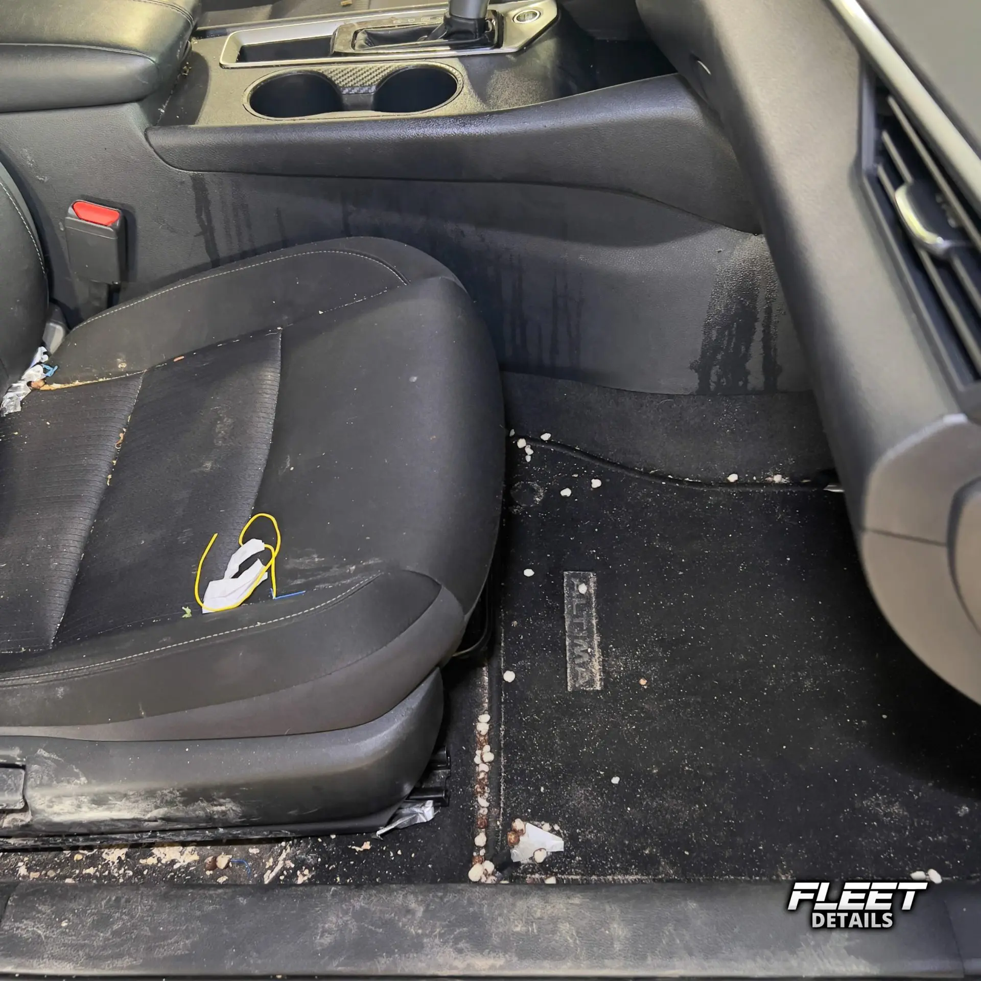 Inside of a vehicle's interior showing the dashboard and seats and carpet cleaned from an interior mobile detail