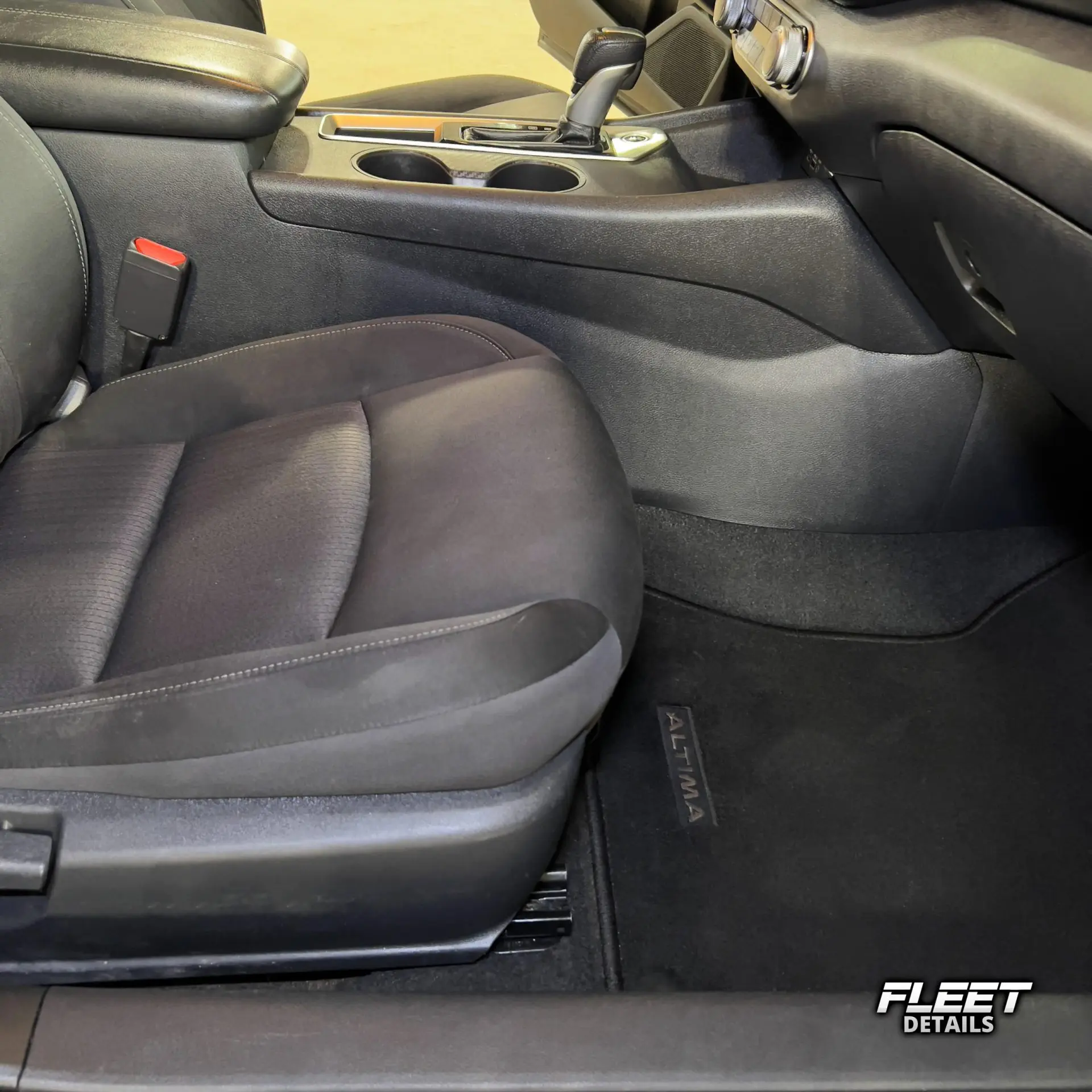 Inside of a vehicle's interior showing the dashboard and seats and carpet cleaned from an interior mobile detail