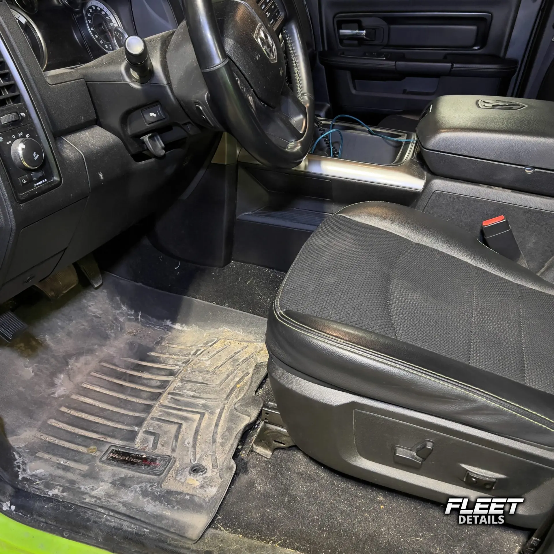 Inside of a vehicle's interior showing the dashboard and seats and carpet cleaned from an interior mobile detail