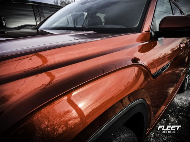 A vehicle receiving a professional ceramic coating by Fleet Details in Rockford, IL. Our ceramic coating services provide unmatched protection against scratches, UV damage, and environmental contaminants, ensuring a long-lasting glossy finish. Contact us for expert ceramic coating near you.